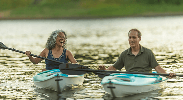 A man and woman kayaking stock photo